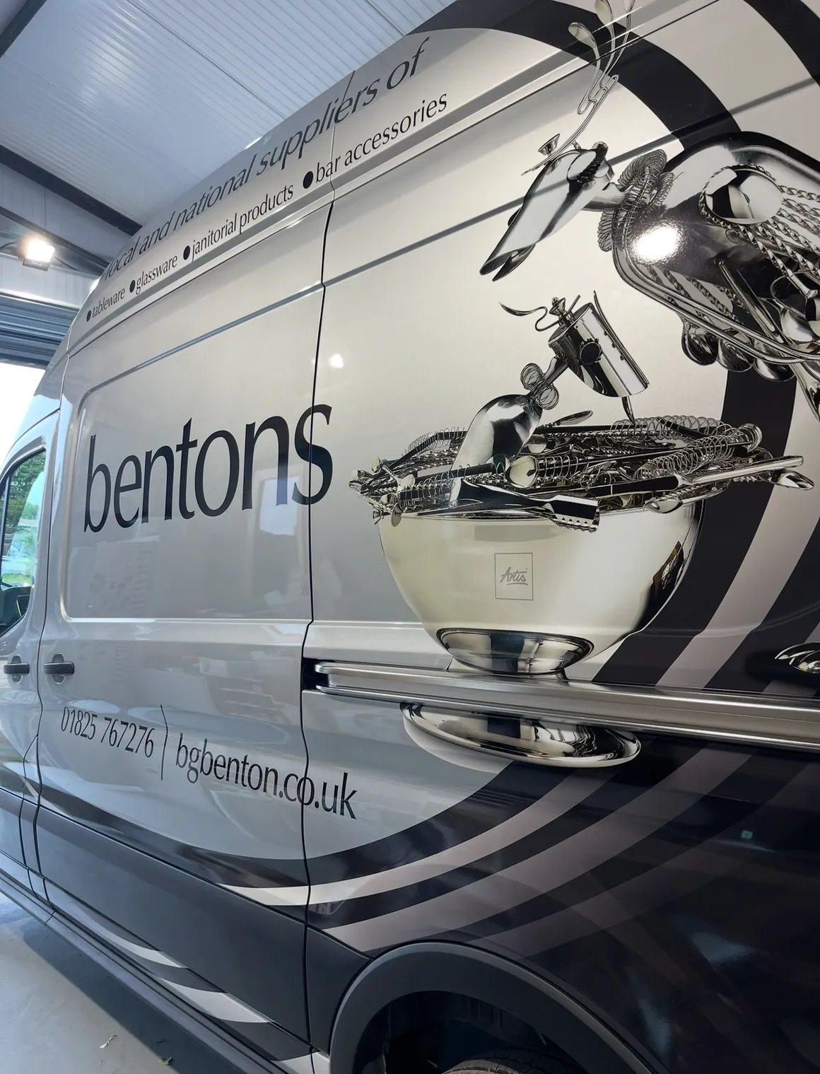 A Mercedes-Benz Sprinter van with a professional branded vehicle wrap featuring company graphics and contact details